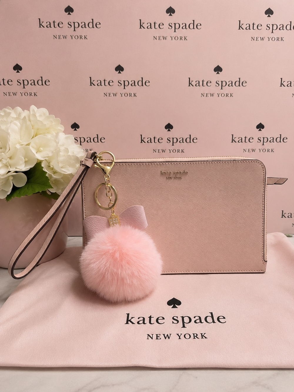 kate spade Blush Pink Leather Wristlet with Gold Hardware With A Pompom Charm